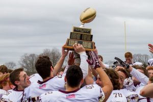 Algonquin Regional players celebrate after winning the Joseph Mewhiney-Richard Walsh Annual Thanksgiving Day Trophy.