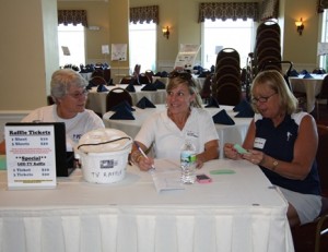 Nancy Fallon of Westborough, Cindy Sowa Forgit of Sturbridge, and Debbie Martell of Ashland work the raffle table at the golf tournament Sept. 20 in Grafton. 