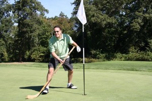 Jason Caterino uses Montalbano's left handed hockey stick to putt the eighth hole. 