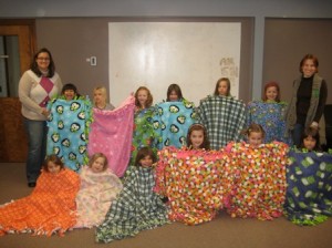 Westborough Girl Scout troop 30195, led by Mary Johnston and Kristen Calhoun, pose with the blankets they made. (Photo/submitted)