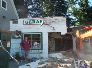 Gerardo Sarli stands in front of his namesake bakery as it is torn down by a crew from Clark & Mott.  Photo/Bonnie Adams