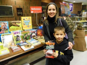 Erika Cota and her son, Diego Cota, 7, enjoy looking at books from the sea. 
