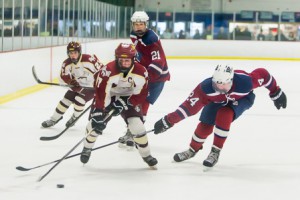 Westborough’s Jed Stone (#24) tries to take the puck from Algonquin’s Brian Ward (#7).