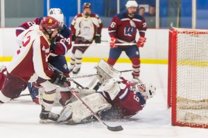 Westborough goalie Jared Ward (#29) ends up on his back after making a save against Algonquin .