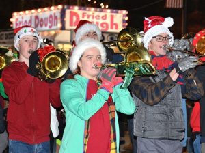 Festively-dressed trombonists of the Westborough High School Marching Band lead the light parade. Photos/Ed Karvoski Jr.