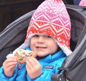 Hadley Jenkins, 3, samples a decorated cookie provided by Yummy Mummy Bakery.