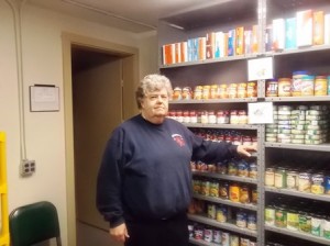 Phil Kittredge, the president of the Westborough Food Pantry, stands in the pantry's storeroom.  Photo/Bonnie Adams 