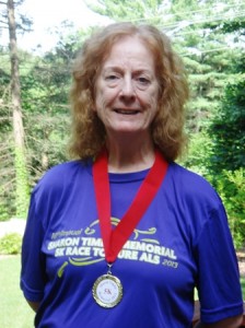  Martha Raphael shows off her medal for winning her division in the Sharon Timlin Memorial 5K Race to Cure ALS.  