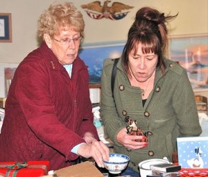 Marianne Rososky and her daughter, Donna Reardon, peruse items at the 13th annual Snowbound Yard Sale, a fundraiser for the Masonic Angel Fund. (Photo/Ed Karvoski Jr.)