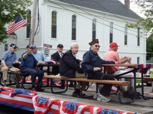 Local veterans wave to well-wishers along the parade route. 