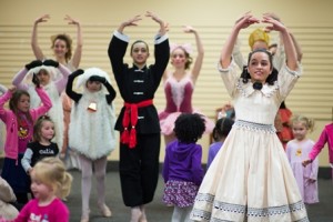 "Clara" and the other dancers teach a dance to the children in attendance. 