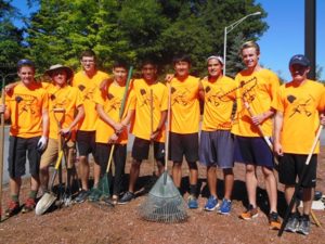 Members of the Cross Country Team take a break from mulching and weeding at the Westborough Senior Center on Rogers Road.