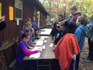 Girl Scouts from Westborough Troop 30507 register Boy Scouts from Troop 382 for the weekend’s Scout-O competition. (Photo/submitted)