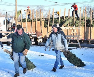 Westborough Civic Club members Rich Connolly and Bill Kohler help unload the first delivery for the 39th annual Christmas Tree Sale.