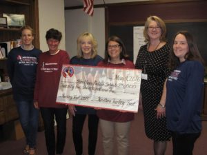 Westborough Superintendent of Schools Amber Bock (fourth from left) receives a check from Turkey Trot committee members (l to r)  Heather Kane,  Maureen Johnson,  Maura Shunney, Marianne O’Connor and Sara Dullea. (Photo/submitted)