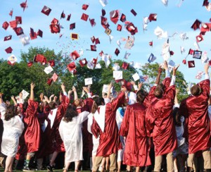 The ceremony concludes with the graduates tossing their caps into the air.