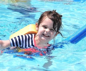 Wellsley Guenette, 2, practices swimming strokes in the pool. 