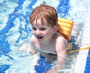 Lukas Siemssen, 2, swims around the pool. 