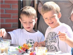 Cooper Often and Jack Biddle, both 5, display a flair for art by painting pumpkins.