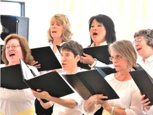 Members of the Hundredth Town Chorus perform under the direction of Wendy Damoulakis.