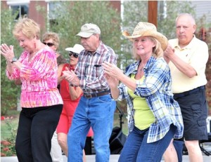 Northborough resident Mary Dragon of the Country Kickers (front) leads a line dance with students from her classes at the senior centers in Hudson, Northborough and Westborough, and the Bay Path Barn in Boylston.