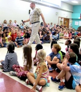 Children's author Dennis Vanasse, strides among students eager to participate in a recent program at the Armstrong School.