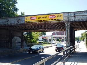 Over the years, a number of trucks have gotten stuck under the bridge in spite of the posted warning signs. 