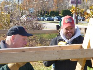 Club members Rich Connolly and Adam Boyce work to set up the tree racks to prepare for the first day of tree sales Saturday, Nov. 26.