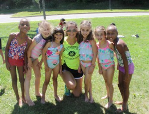 (l to r) Isabella Martinez, Mia Keegan, Melissa Soares, Chloe Geiman, Sienna Geiman and Evie Martinez wait in line for the waterslide with camp counselor Meredith Wolpert.