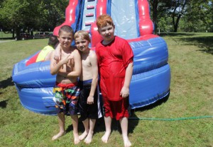 Camp friends (l to r) James Barry, Aiden Lenahan-Steele and Ben Bartlett enjoy the waterslide together. 