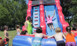 Camp Manager Mike Orfao takes a turn on the waterslide.