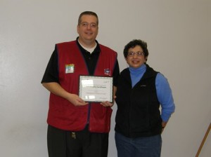 Lowe's Manager Mike Lively receives a community certificate from Judith Wilchynski of the Westborough Girl Scouts. (Photo/submitted)