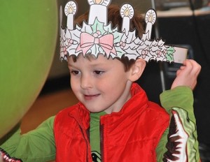 Dominic Testagrossa, 6, adjusts the Advent wreath crown that he colored.