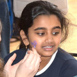 Saanvi Dondapati, 9, gets her face painted. Photo/Ed Karvoski Jr.