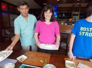Cheng Du's owner Tang Kuo Rung looks on as Ali Leva shows off her sushi rolls. 