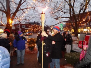 The “Shamash” (the torch used to light the menorah) is passed around before the menorah is lit. 
