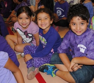 Maryori Campos, Danielle Guimaras and Jordyn Reyes, from Cheryl Collins' class, enjoy the special assembly to kick off Purple Day. (Photos/Nance Ebert)