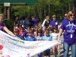 Principal Becker leads the preschool on their lap around the building on Purple Day, raising funds for Relay for Life's "Recess Relay."