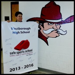 Sarah Carver, athletic trainer at Westborough High School, shows off the banner commemorating the school's award. (Photo/submitted)