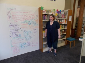 New Westborough Teen Librarian Jen McGrath in front of the giant white board, one of the ways she hopes to solicit input from local teens. (Photo/Valerie Franchi)