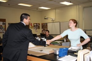 Monica Hayes, a Bio-technology teacher, shakes hands with Gomez.