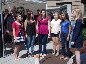 The Westborough High School a cappella group, Harmony in Heels, performs the  national anthem.