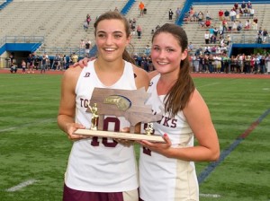 Algonquin Regional High School co-captains Taylor O'Connell (left) and Hannah Lindgren (right) hold their Central Massachusetts Girls Lacrosse Division 1 trophy. 