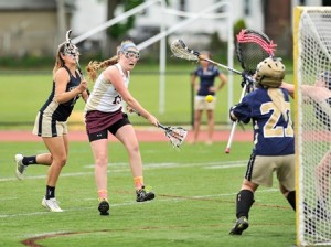 Algonquin Regional High School's Emily Hart (#19, center) shoots against Shrewsbury High Schools Jamie Matys (right) in front of Shrewsbury's Melissa Duva (#17, left).
