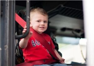Hunter, 3, from Auburn, takes a seat in the fire truck. 