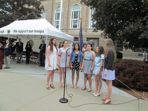 Westborough High School’s a cappella group sings the National Anthem in front of the Forbes Municipal Building.